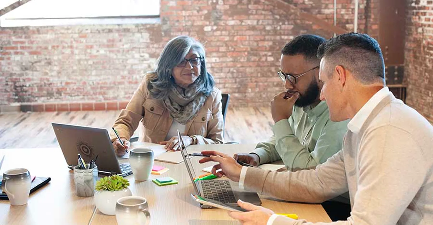 Sales representative speaking customers around a table