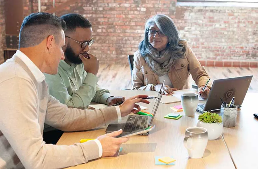 Sales reps sitting around a conference table