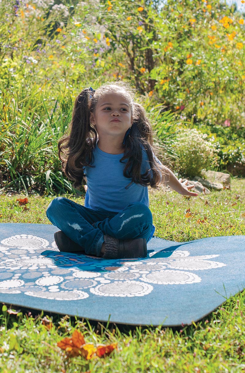 Girl sitting on a Mindfulness Mat