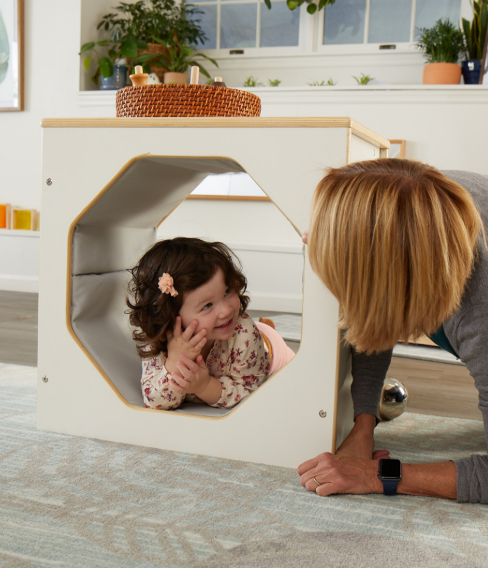 Girl crawling through Honeycomb Tunnel