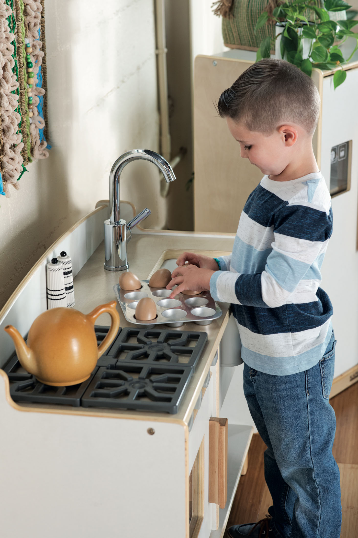 Child playing with kitchen