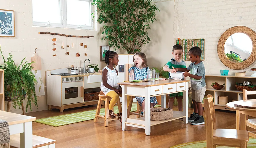 Young children gathered around the Sense of Place kitchen island with other Sense of Place kitchen furniture around them
