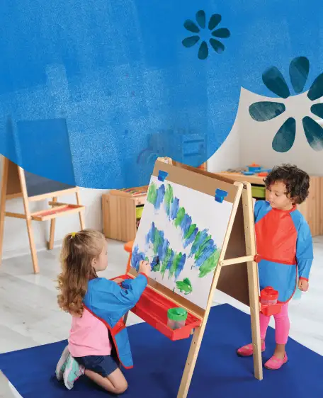 Children painting on an easel