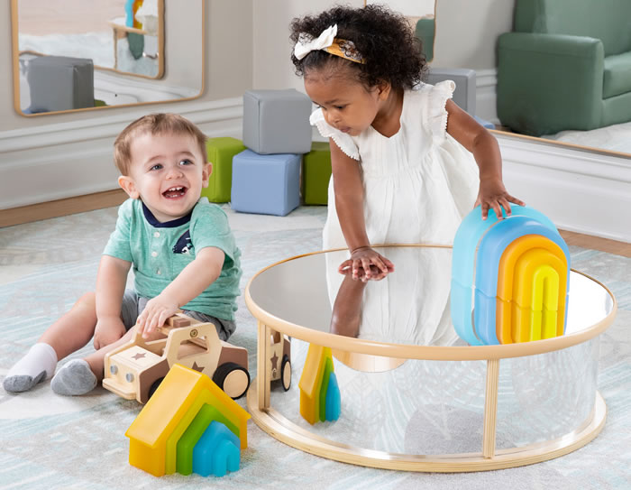 Two toddlers playing at a table