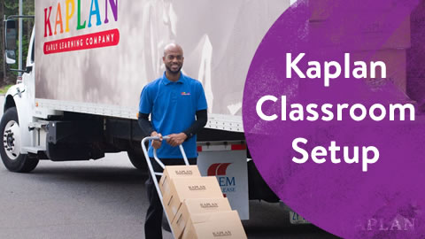Kaplan Delivery Specialist with a hand truck of boxes walking into center