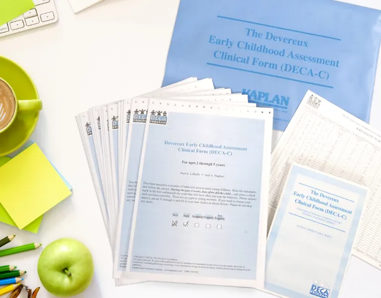 Teacher handing a parent a copy of Promoting Resilience For Now and Forever booklet