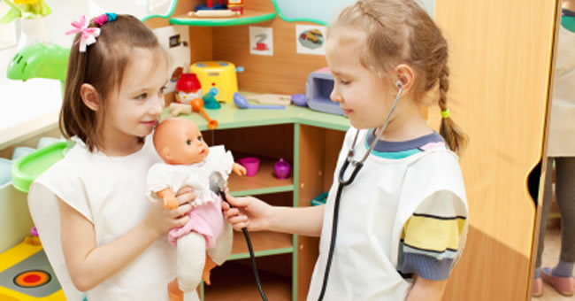 toddlers playing with baby dolls