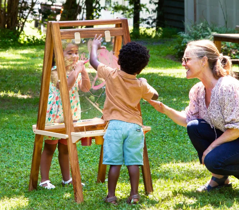 Children using an art easel outdoors