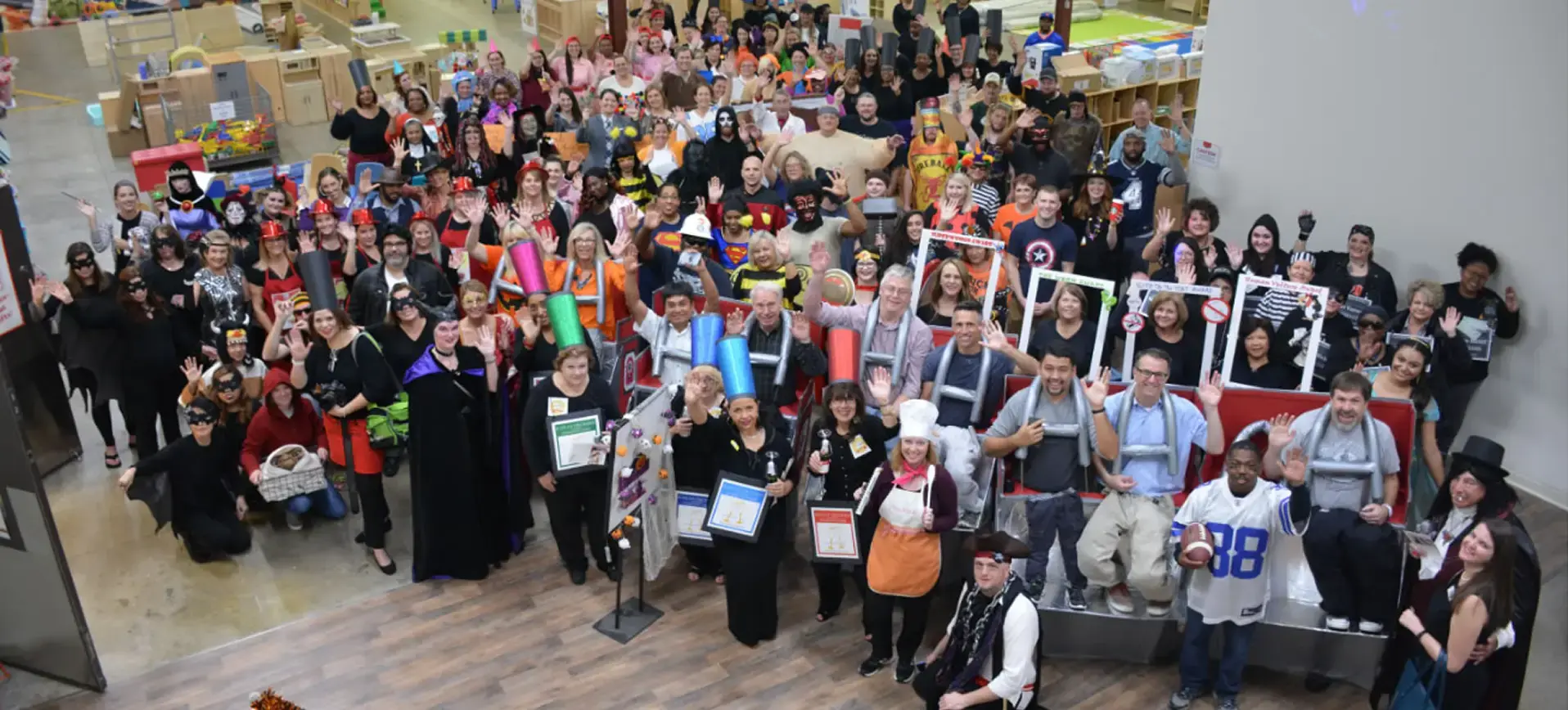 Large group of Kaplan employees dressed in halloween costumes