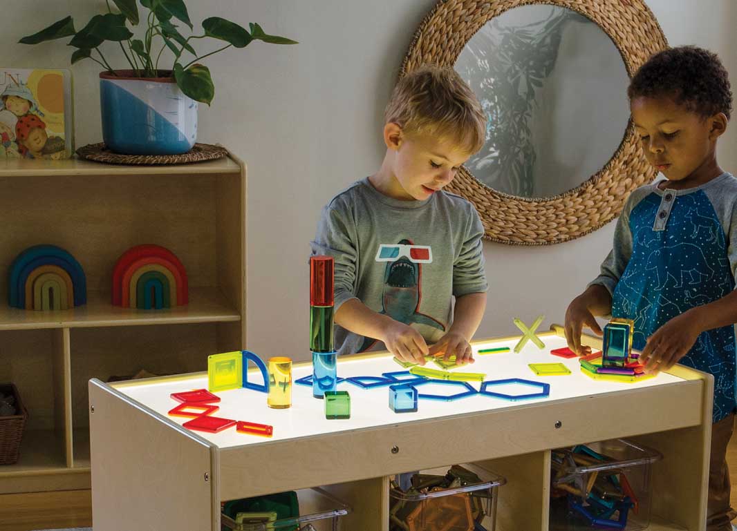 Two children playing on the Magnetic LED STEM Center