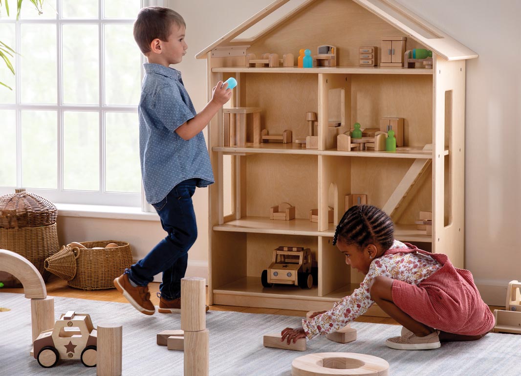 Children playing with the Multi-Level Classroom Dollhouse