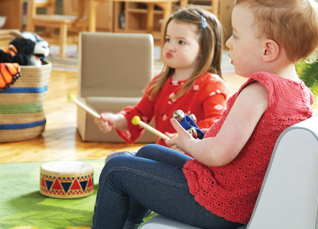 Two children playing with musical instruments