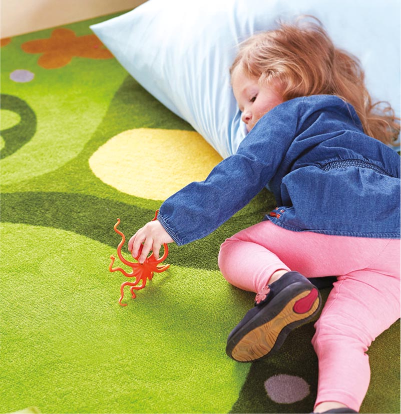 Girl resting on Falling Leaves Carpet and Natural Pillows