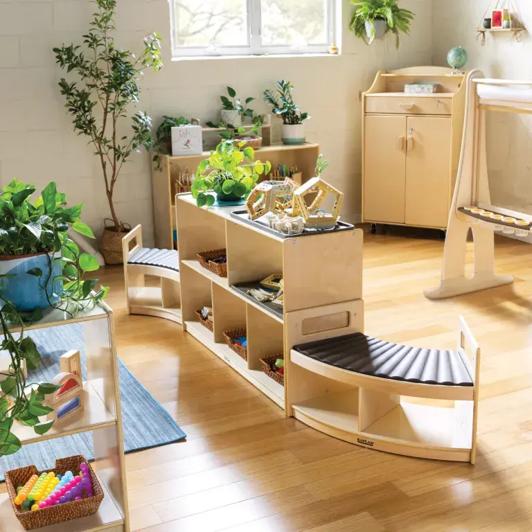 Carolina Connections Rhythm Seating benches placed on either side of a small shelf unit in a preschool classroom