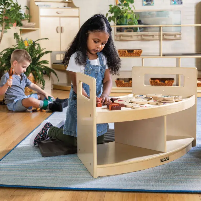 Girl playing with wooden toys on the Carolina Connections Rhythm Seating bench