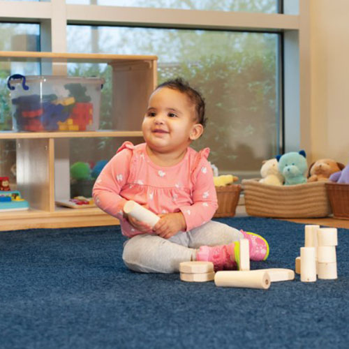 Toddler Playing with Wooden Blocks