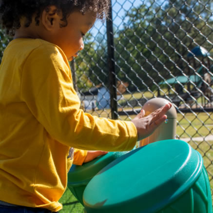 Child Playing with Toy Drums