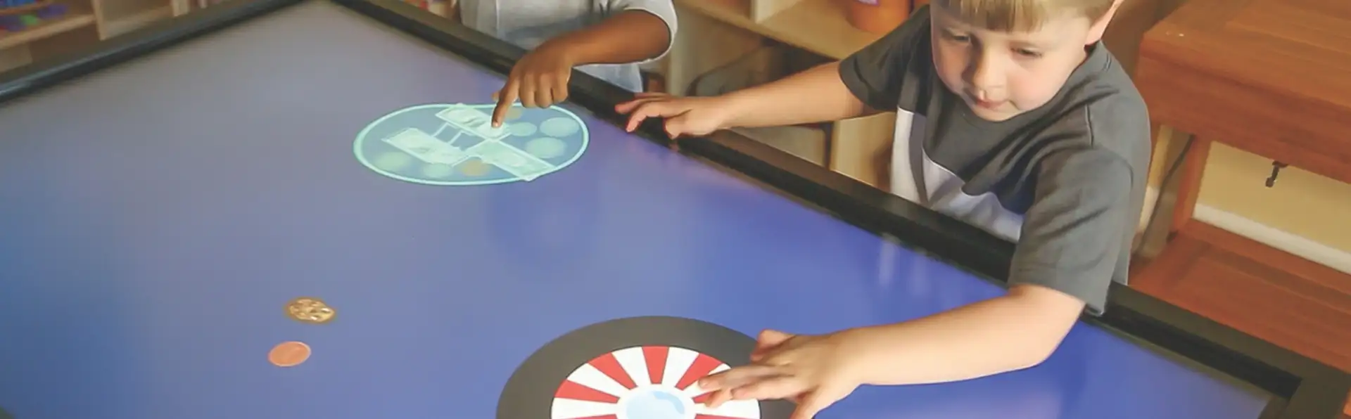 Two children playing on the Inspire Jr. Interactive Panel