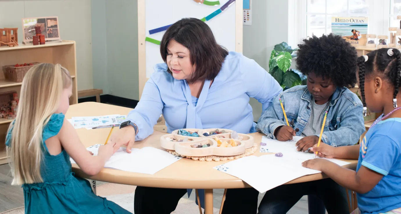 Preschool teacher at a table doing activities with children