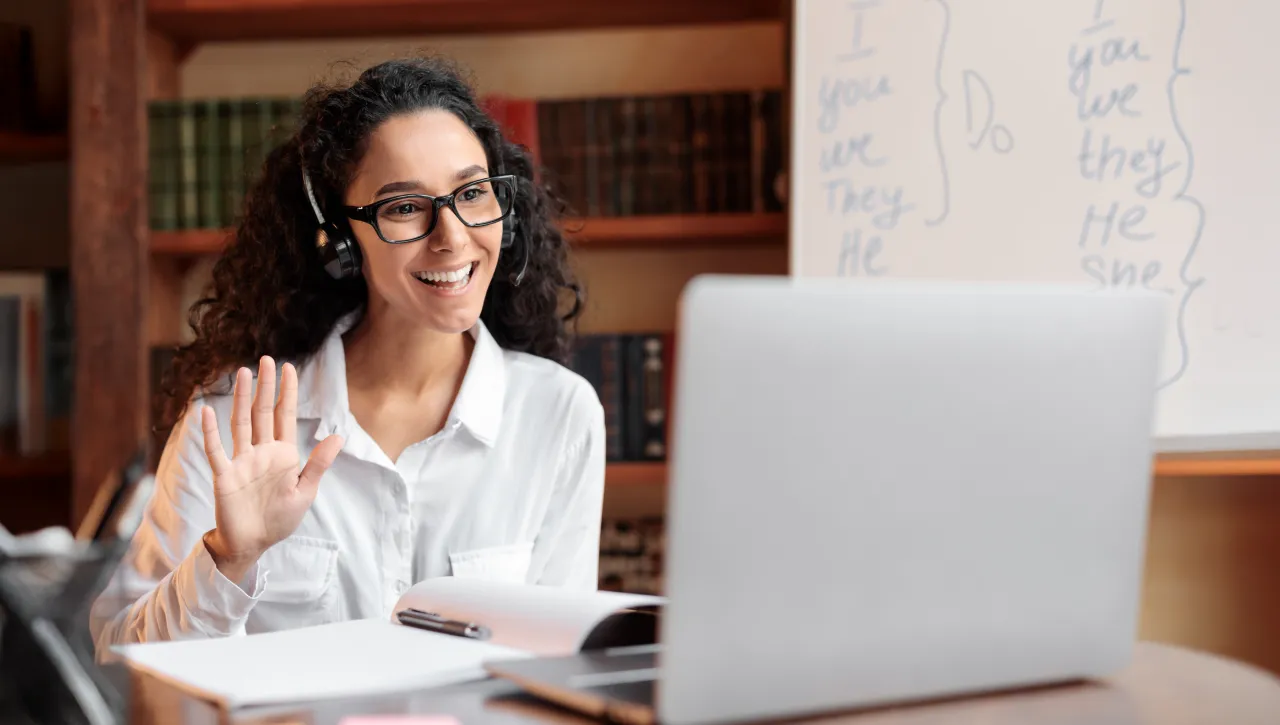 Woman participating in a virtual training session on a laptop