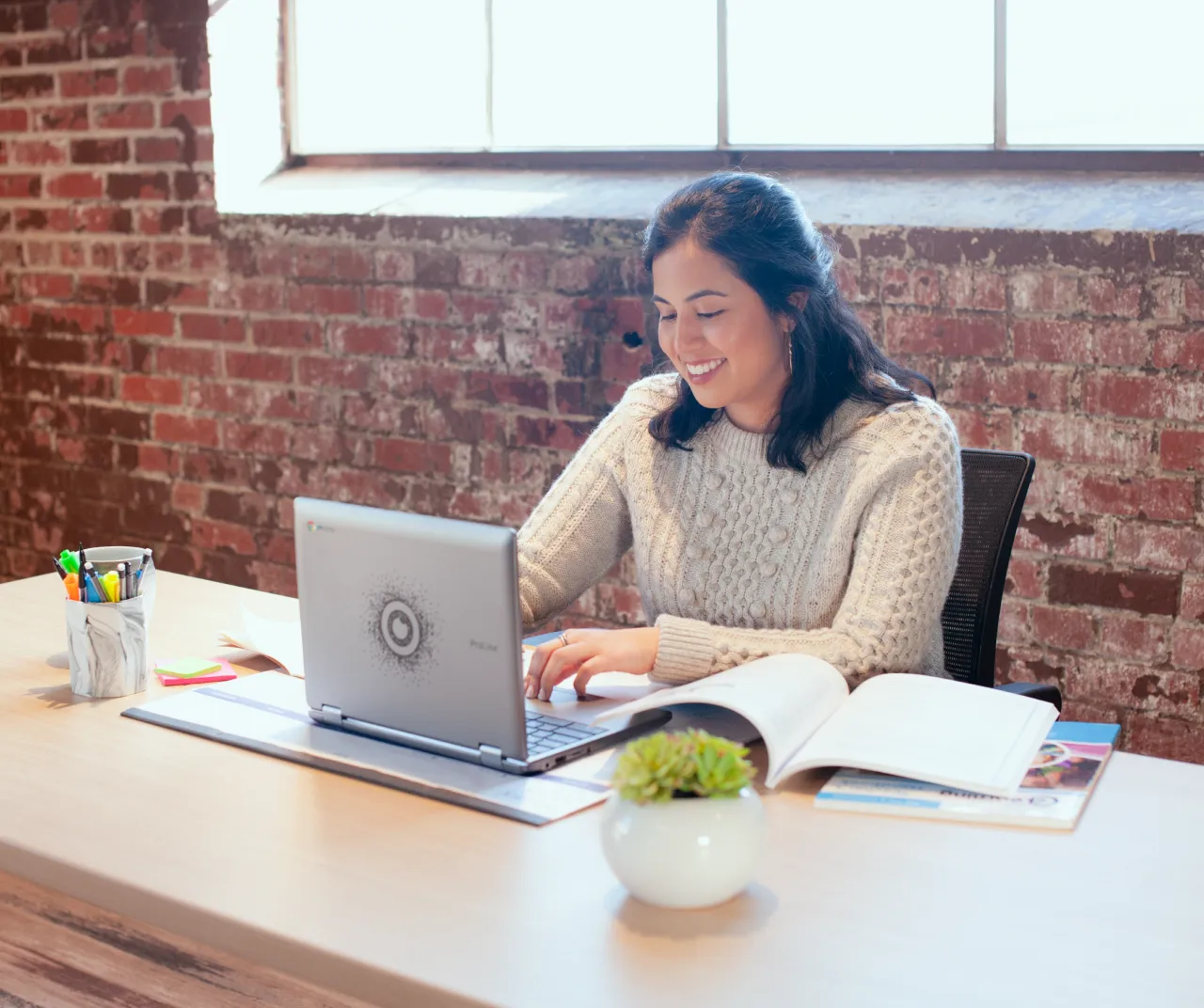 Woman at a desk working on a laptop