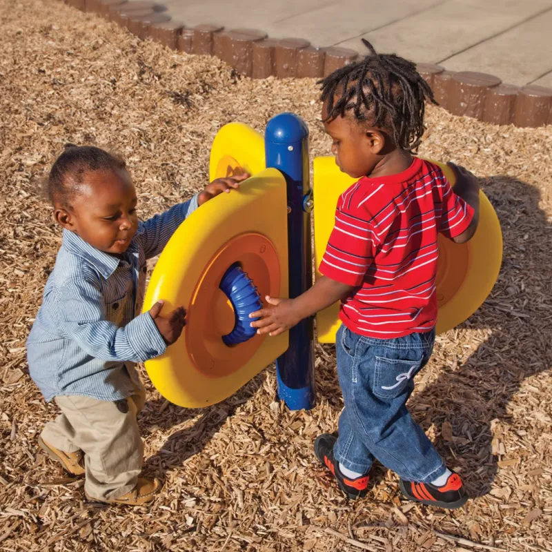 Small children playing around a playground set