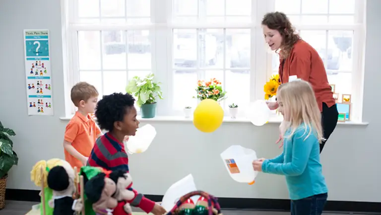 Children and teacher interacting in a classroom