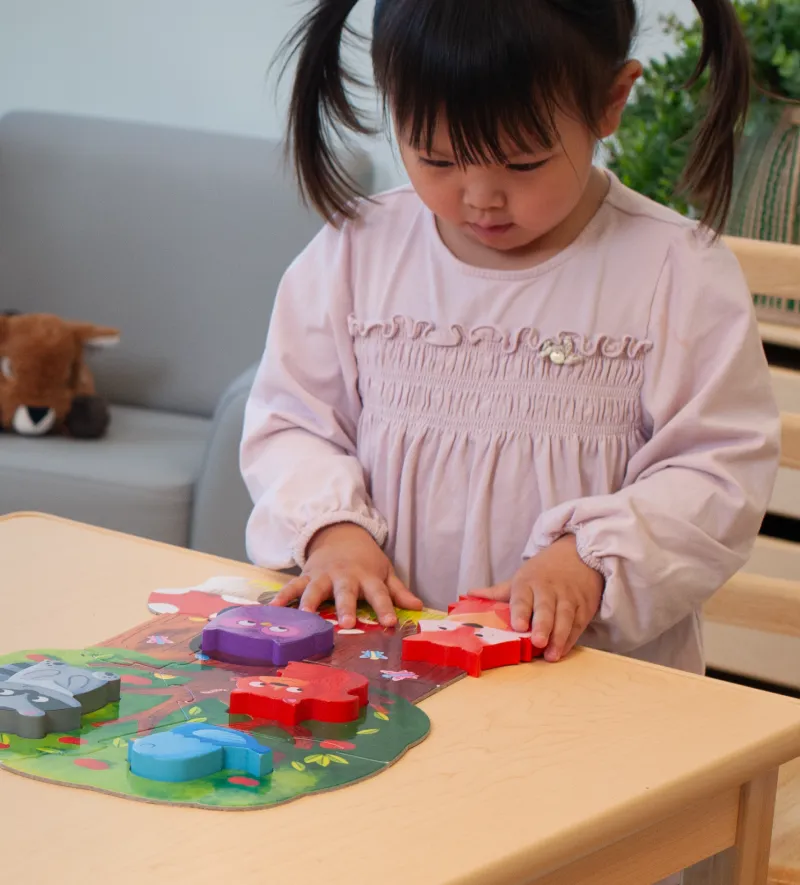 Young girl playing with 3D puzzle