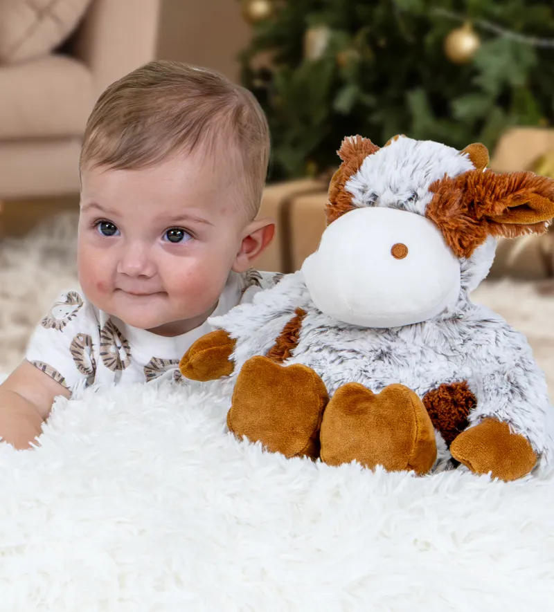 Baby holding stuffed cow