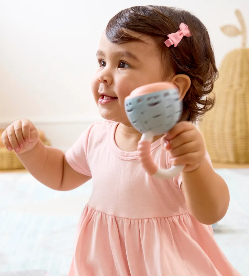 Baby shaking a rattle