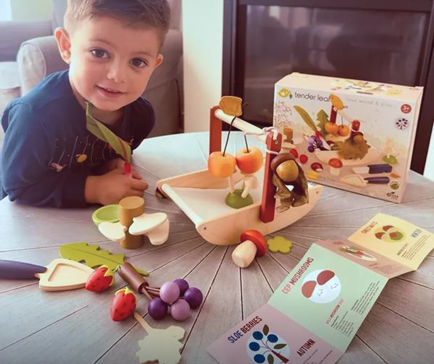 Boy playing with Wild Wood Foraging Trug Wooden Playset