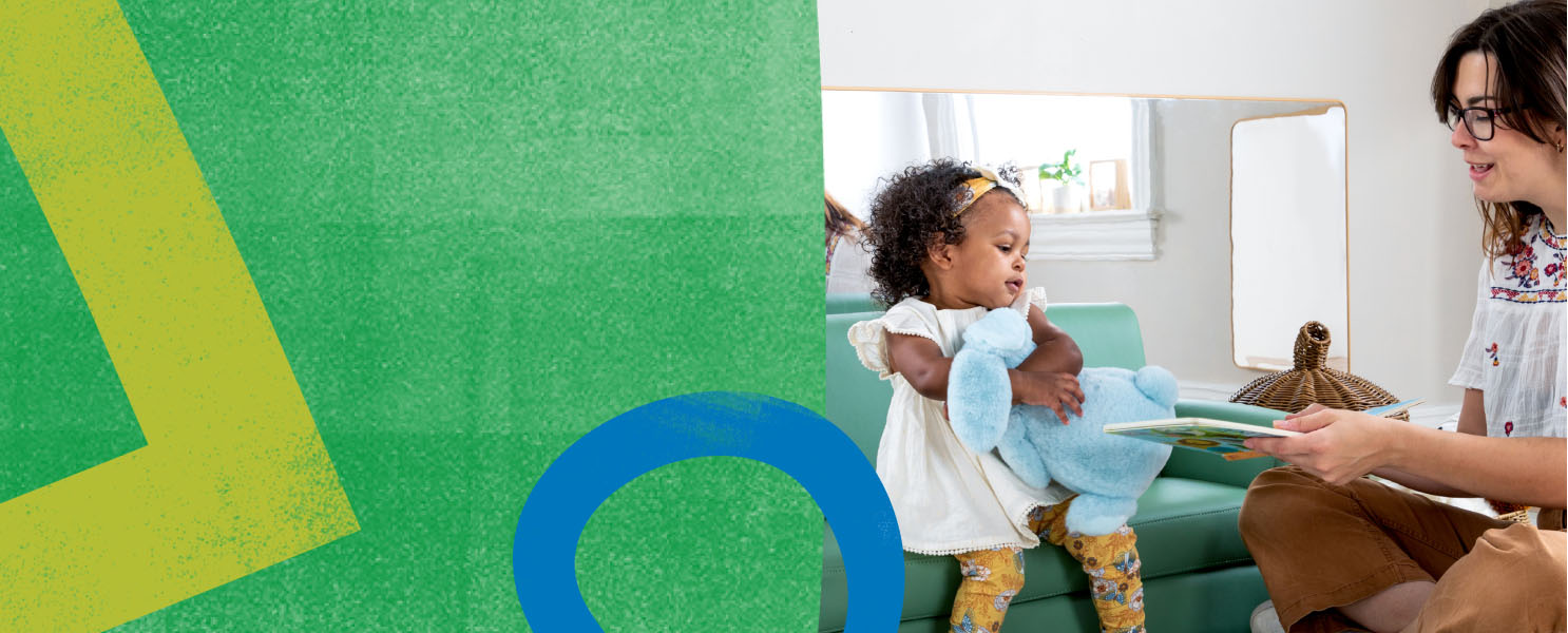 Teacher reading to small child sitting on a couch