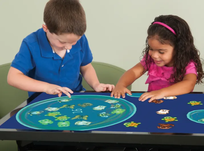 Two children playing a game on the 55 inch Inspire Interactive Panel