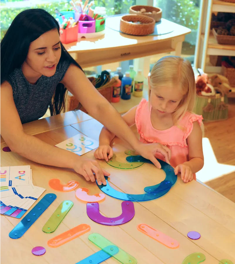Teacher using a hand puppet to teach young children