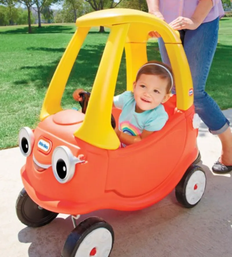 Young child riding in a toy car