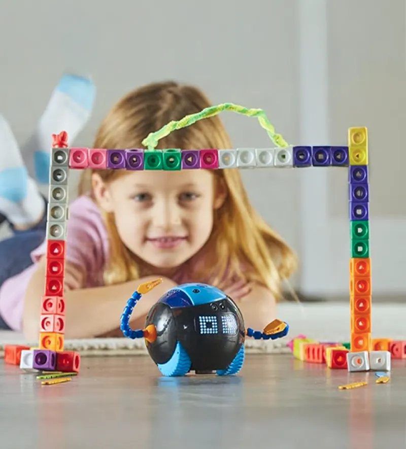 Teacher sitting in a glider reading to a child on her lap