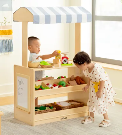 Children playing at a produce stand playset
