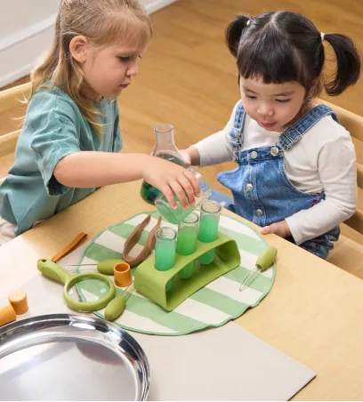 Children using beakers and other scientific instruments