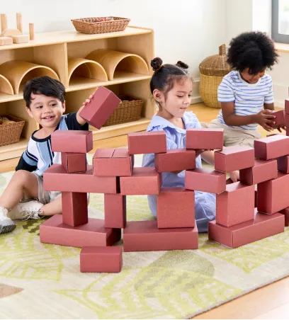 Children building with paper blocks in a classroom
