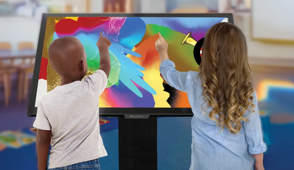 Two children playing games on a large touchscreen panel