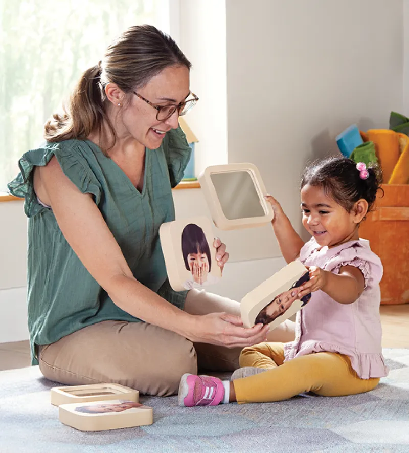 Three shelf storage unit with baskets and toys on it
