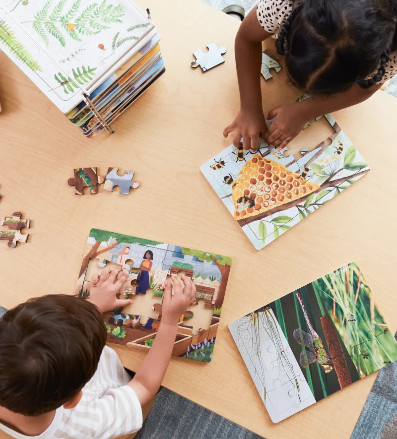 Teacher sitting in a glider reading to a child on her lap