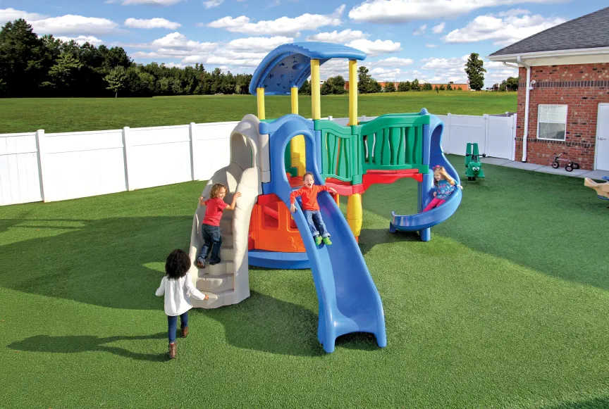 Childen playing on a colorful playset on a playground