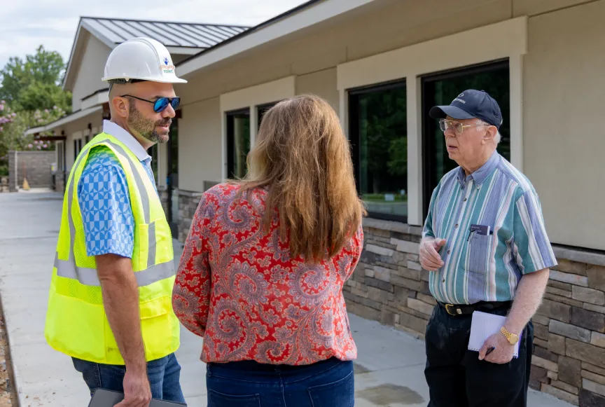 A playground specialits discussing a playground design with a customer