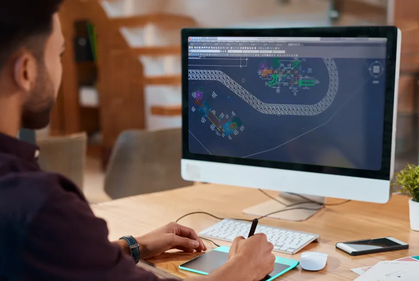 Person using a computer to render playground CAD designs