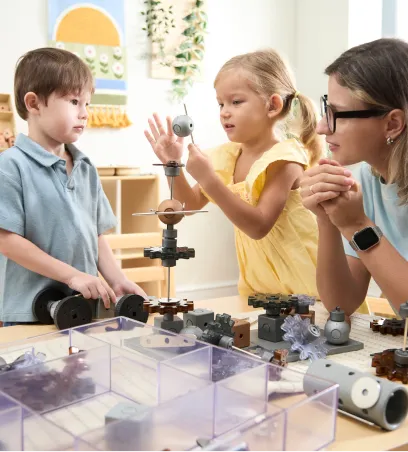 Teacher and children building with toy gears