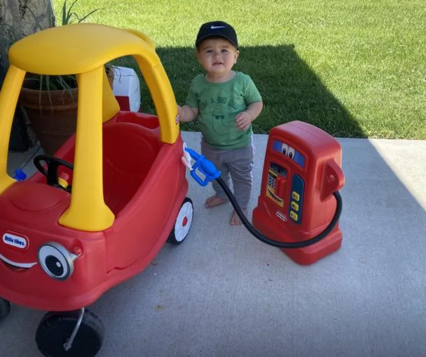 Boy playing with Little Tikes Cozy Coupe