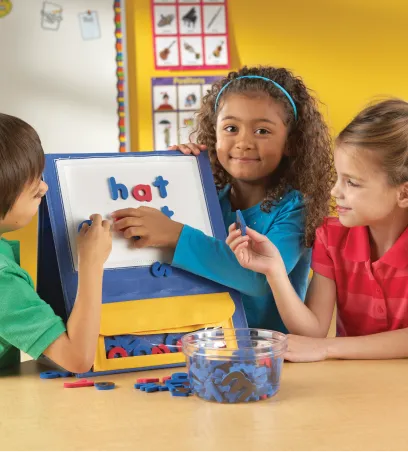 Children using a magnetig board with letters