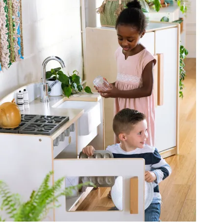 Children playing with a kitchen play set