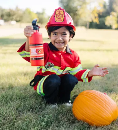 Boy in a firefighter's uniform costume